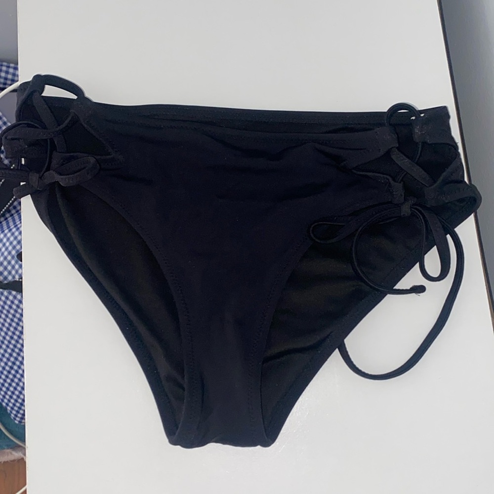 black full coverage swimsuit bottoms with ties on the sides